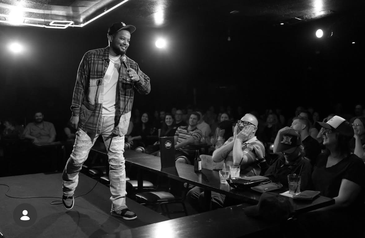 Ron G performing beside an audience